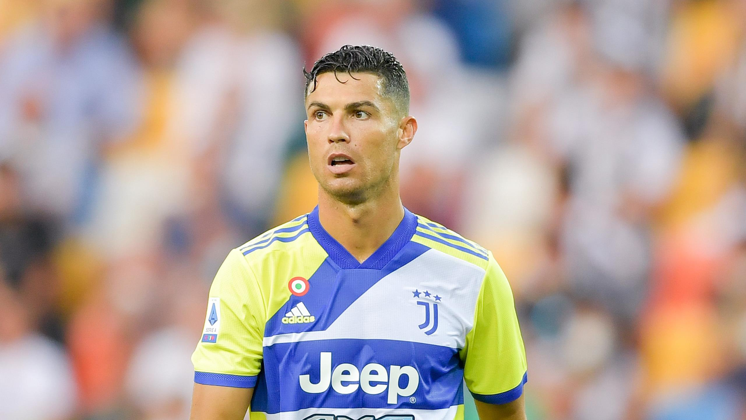 Cristiano Ronaldo CR Is Standing In Blur Audience Wallpaper Wearing Yellow Blue Sports Dress 2K Ronaldo