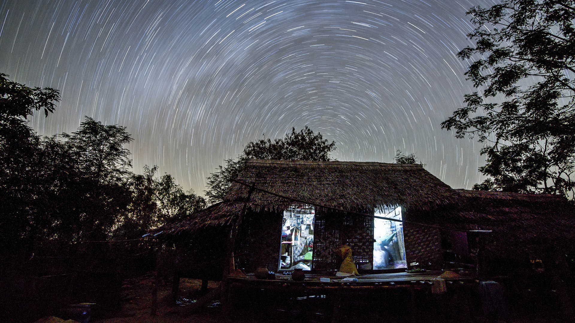 Hut And Trees With Wallpaper Of Star Trails 2K Space