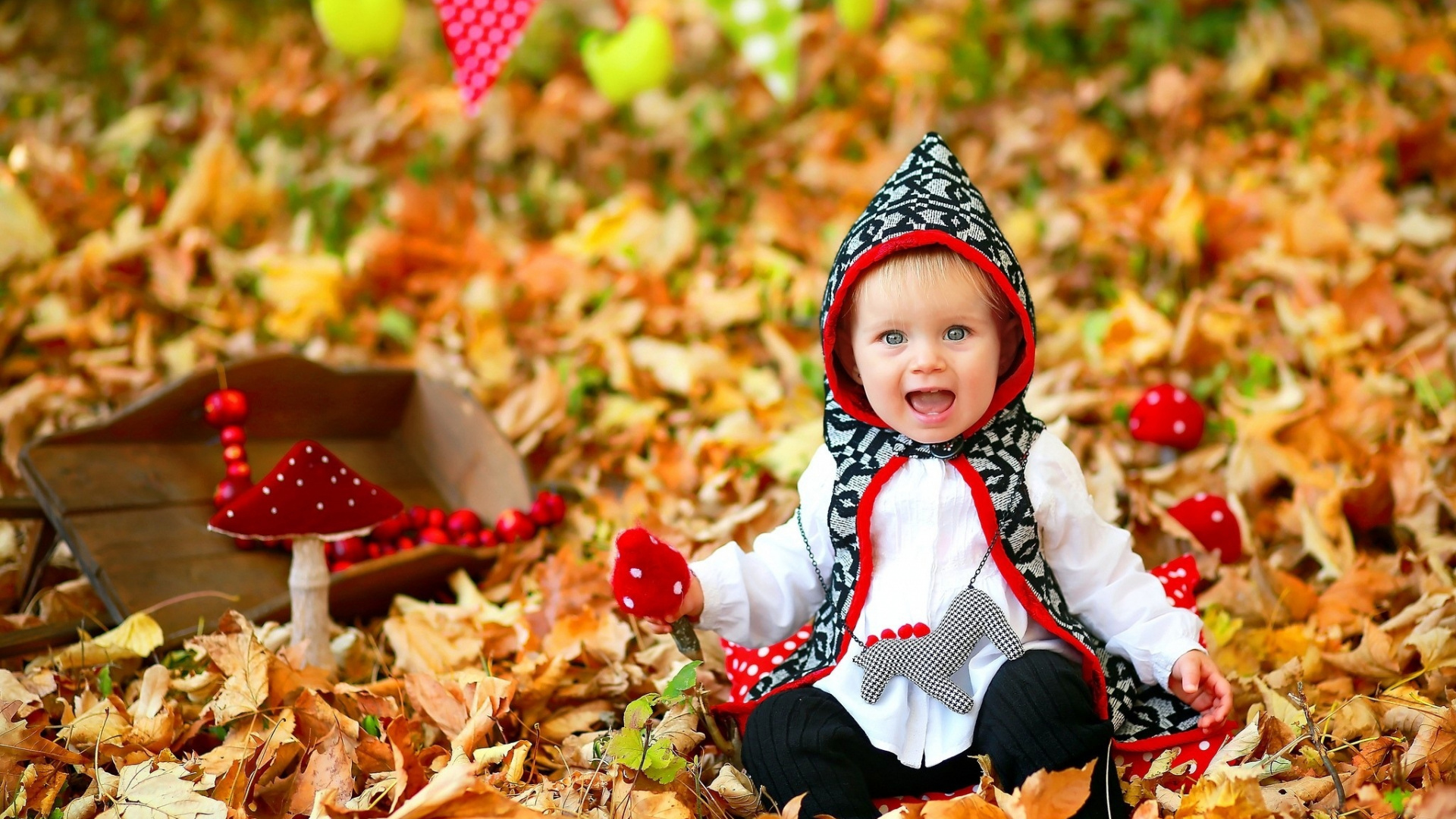 Cute Gray Eyes Baby With Open Mouth Is Sitting On Dry Leaves Wearing White Black Dress In Blur Dry Leaves Wallpaper 2K Cute
