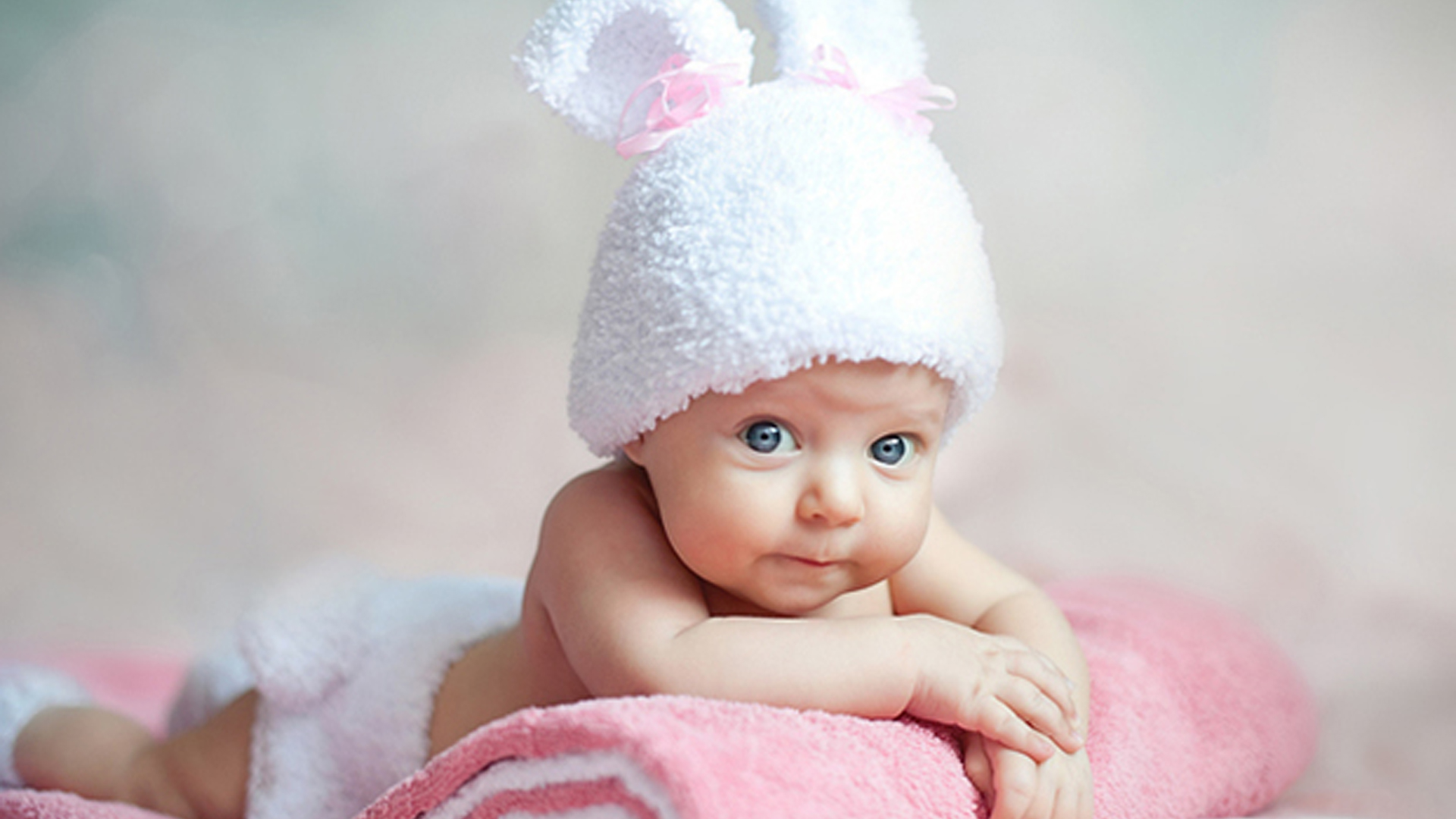 Grey Eyes Cute Toddler Is Lying Down On White Pink Bath Towel Wearing White Woolen Knitted Cap 2K Cute