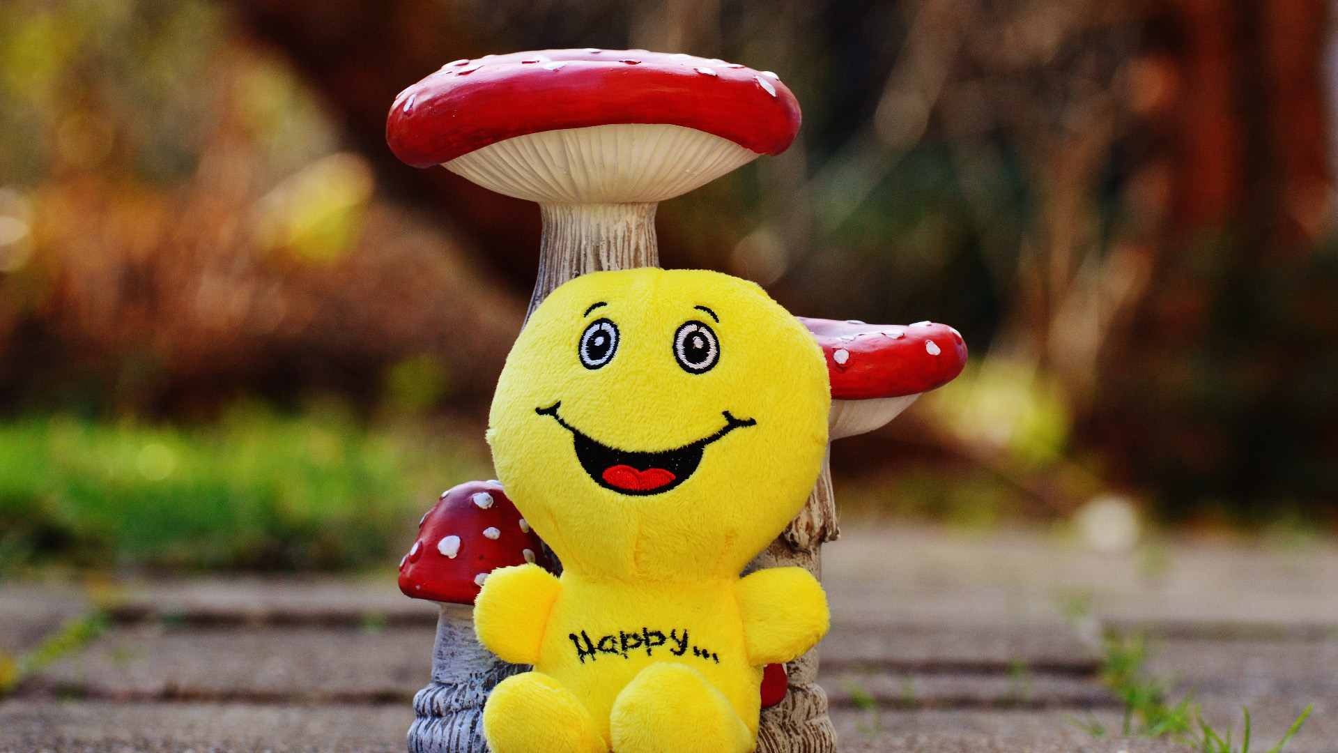 Yellow Emoji Leaning On Toy Mushrooms 2K Emoji