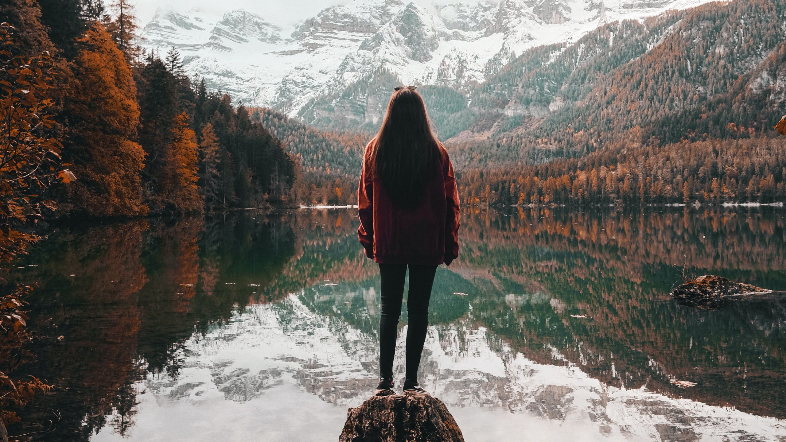 Girl Is Standing Alone On Rock Stone Near Lake With Reflection Of Mountains And Trees 2K Alone