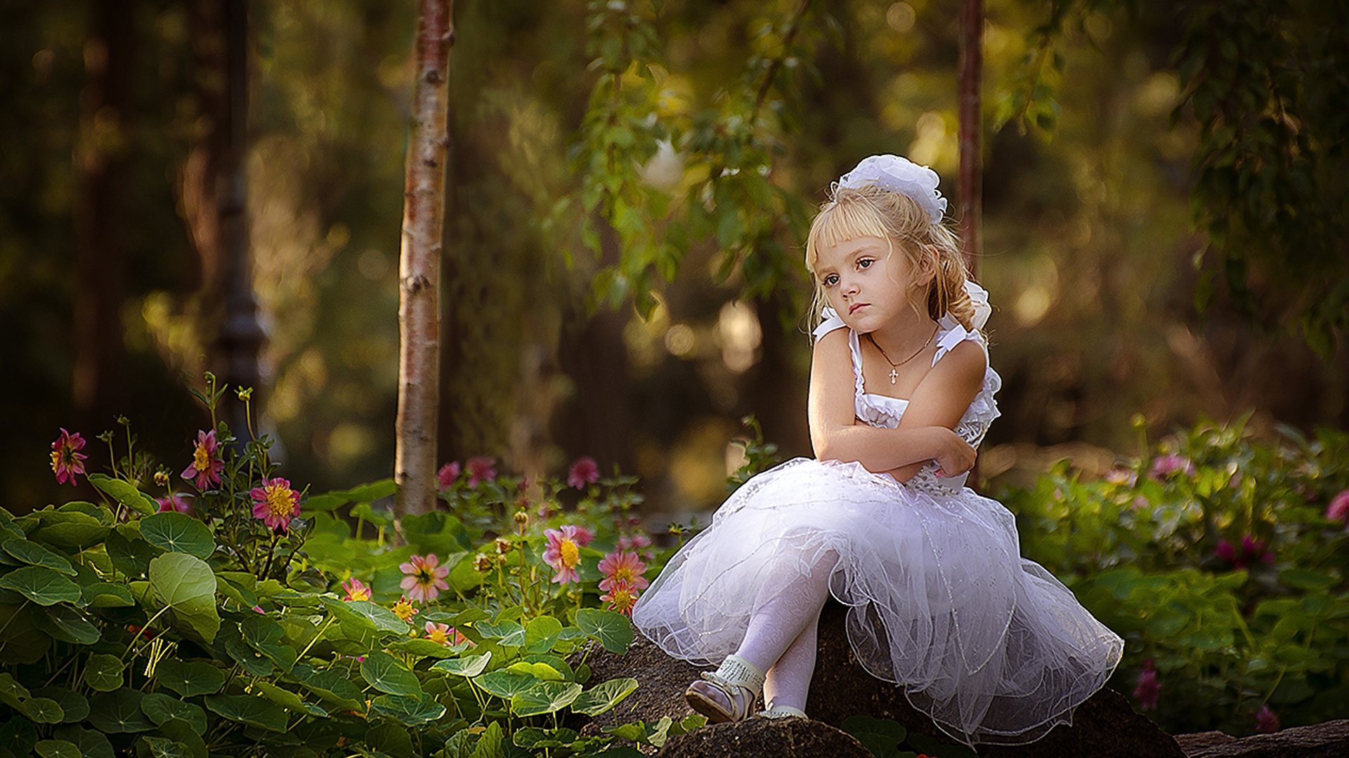 Cute Little Girl Is Sitting On Rock Wearing White Dress In Blur Wallpaper 2K Cute