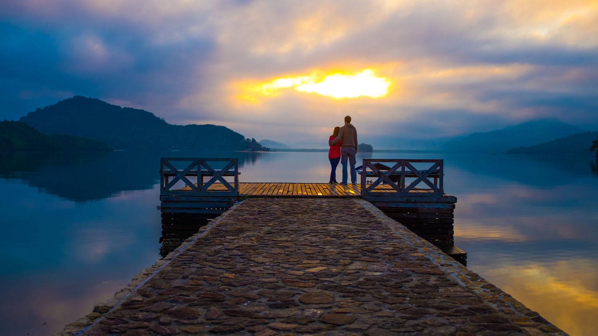 Couple Standing On Wood Dock In Yellow Blue White Sky Wallpaper 2K Couple