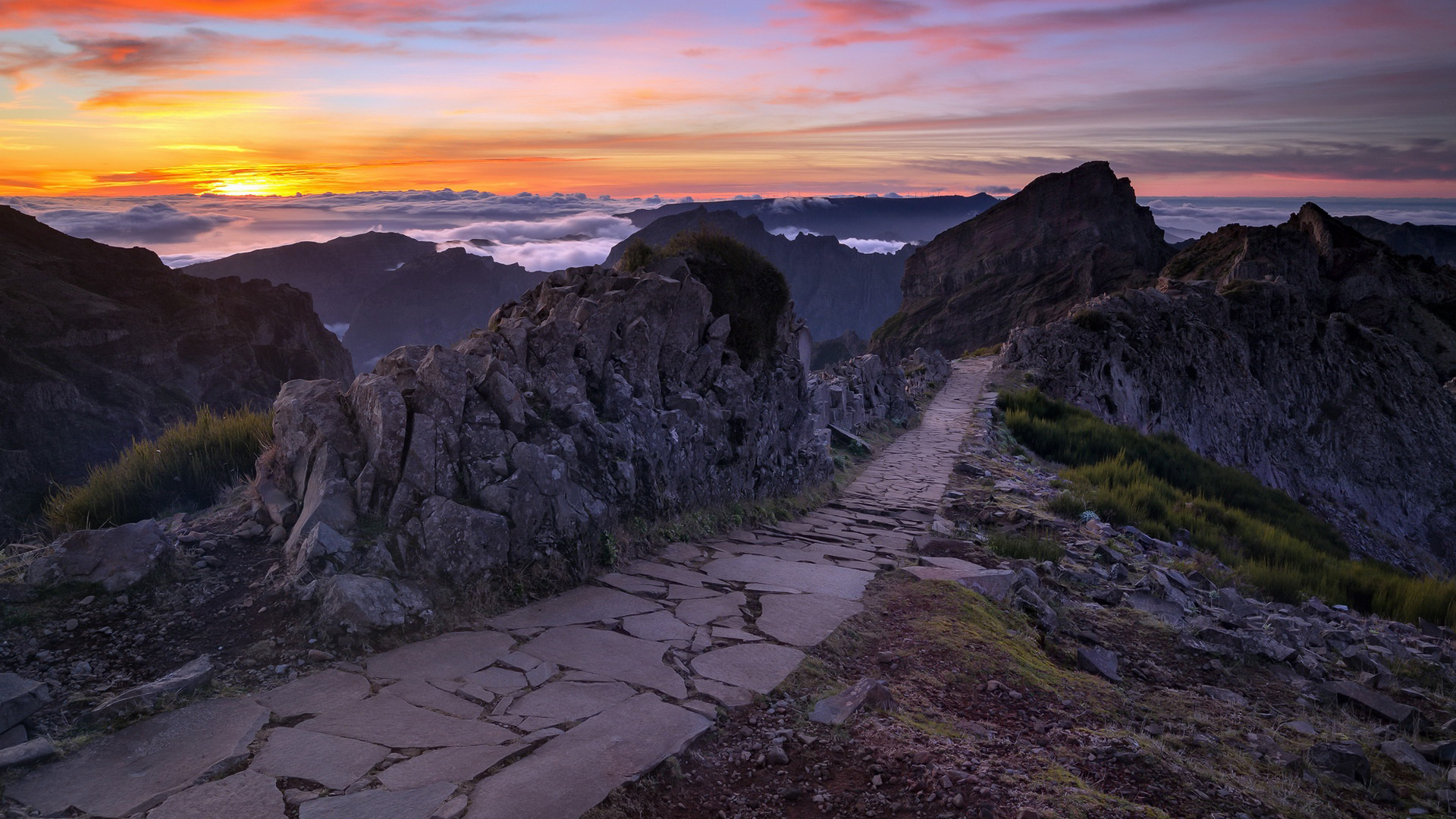Stone Path Between Green Grass Field And Rock Mountains During Sunset 2K Nature