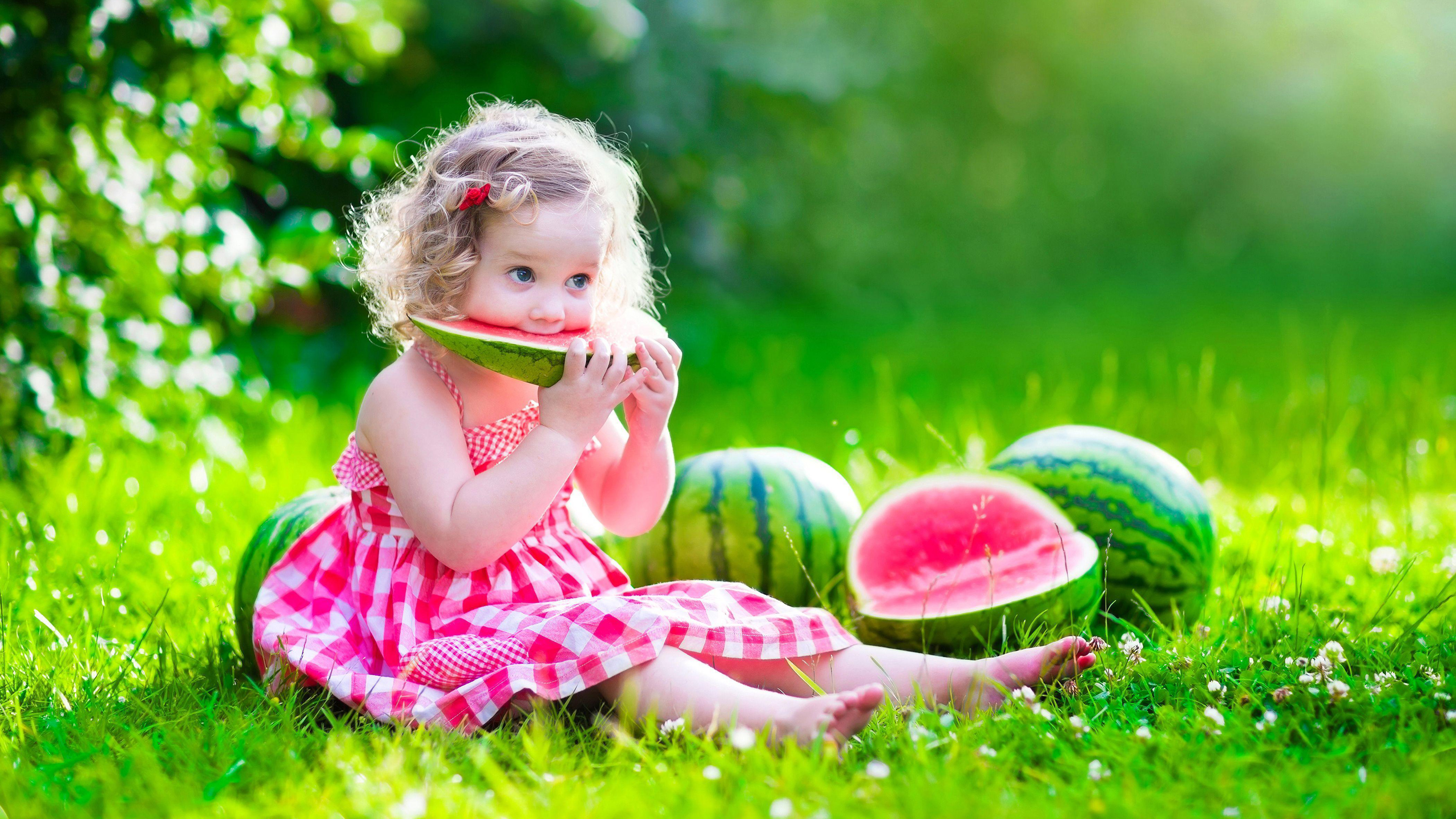 Cute Baby Girl Is Sitting On Green Grass Eating Watermelon Wearing Pink Dress K 2K Cute
