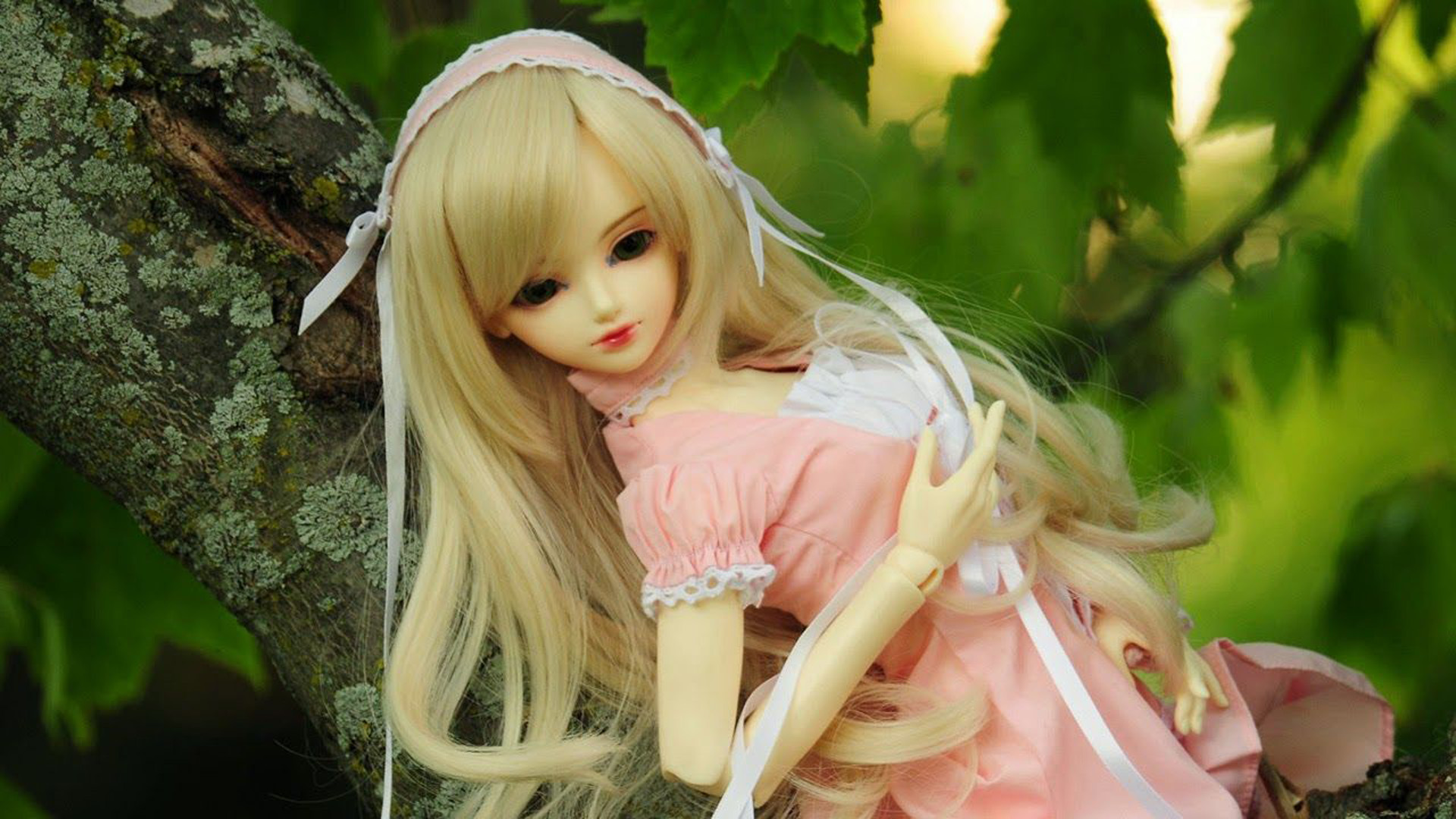 Cute Barbie Doll On Tree Branch In Blur Green Leaves Wallpaper 2K Barbie