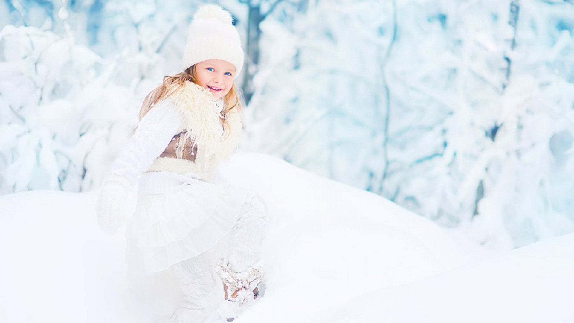 Blue Eyes Smiley Cute Little Girl Is Wearing White Woolen Knitted Dress And Cap Standing In Snow Field Wallpaper 2K Cute