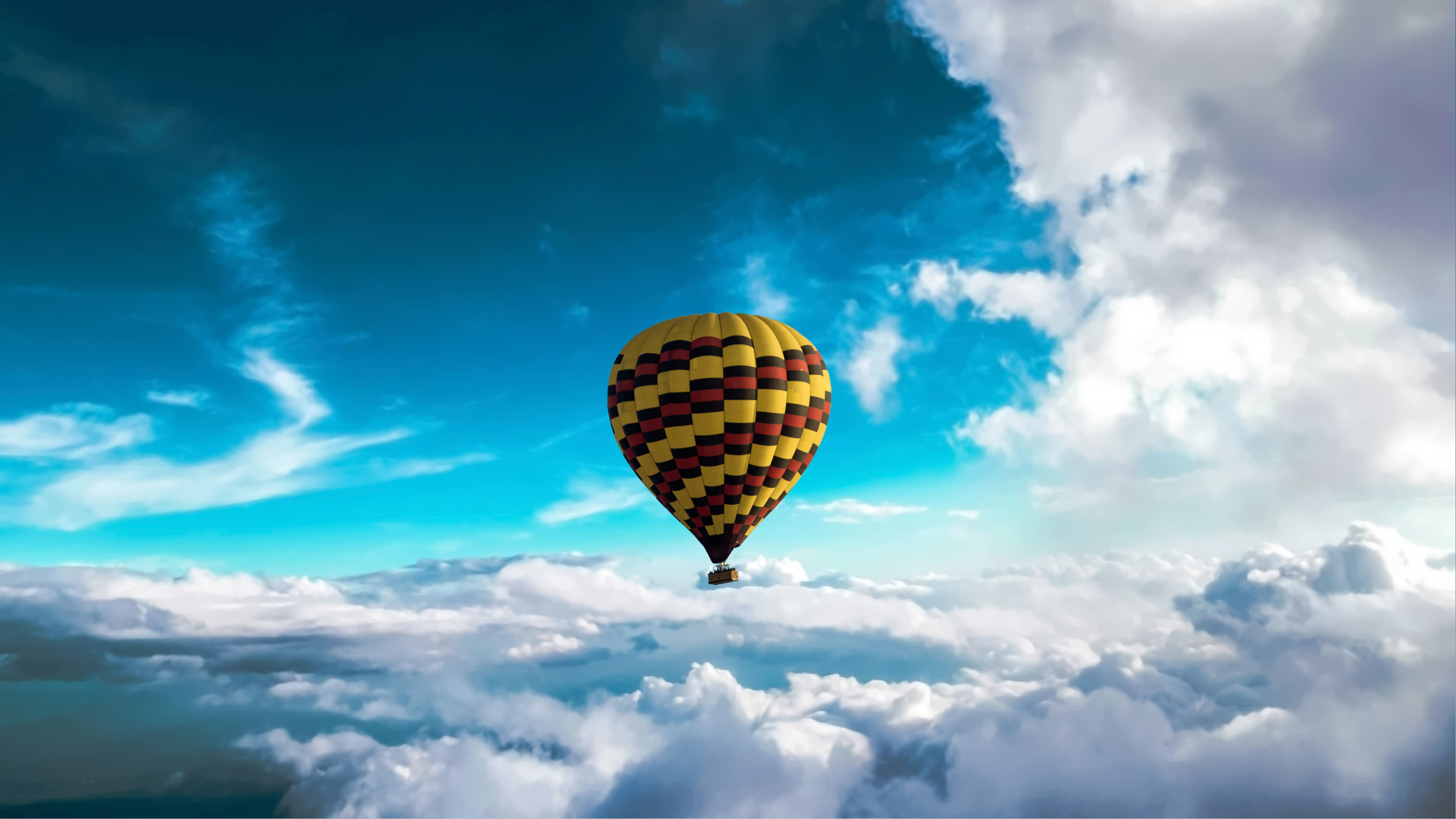 Hot air balloon above clouds K