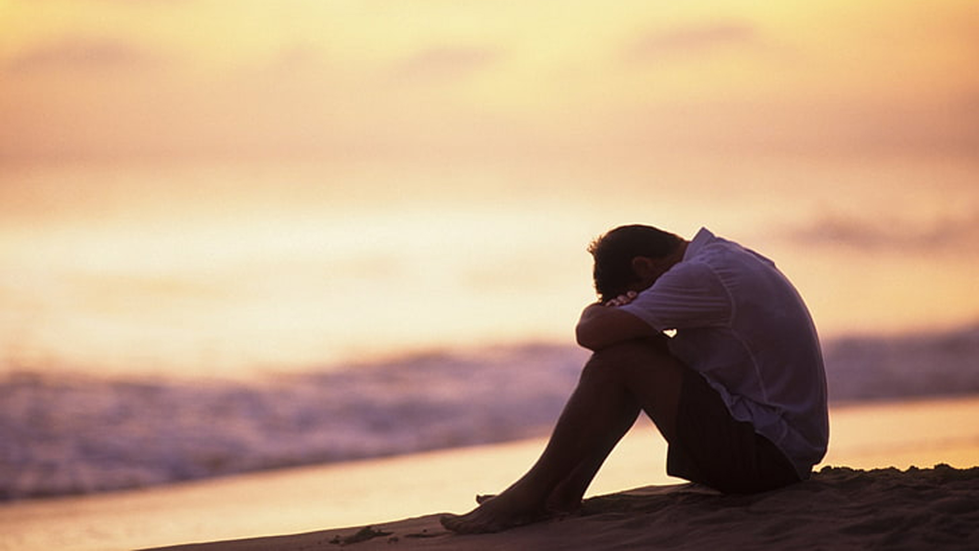 Sad Depression Man Is Sitting Alone On Beach Sand In Blur Sky Wallpaper 2K Depression