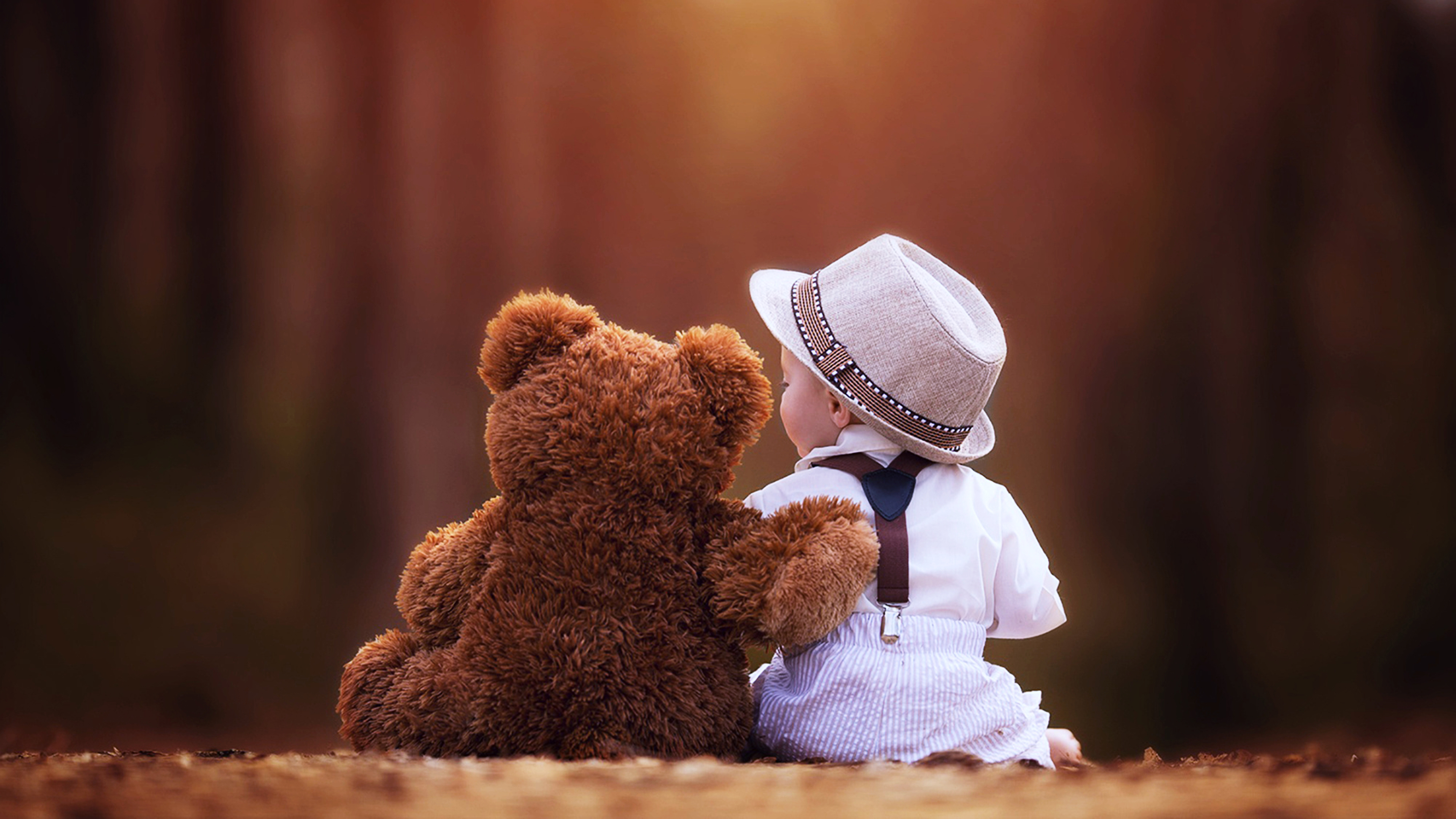 Backside Of Cute Baby Is Wearing White Dress And Hat Sitting With Teddy Bear K 2K Cute