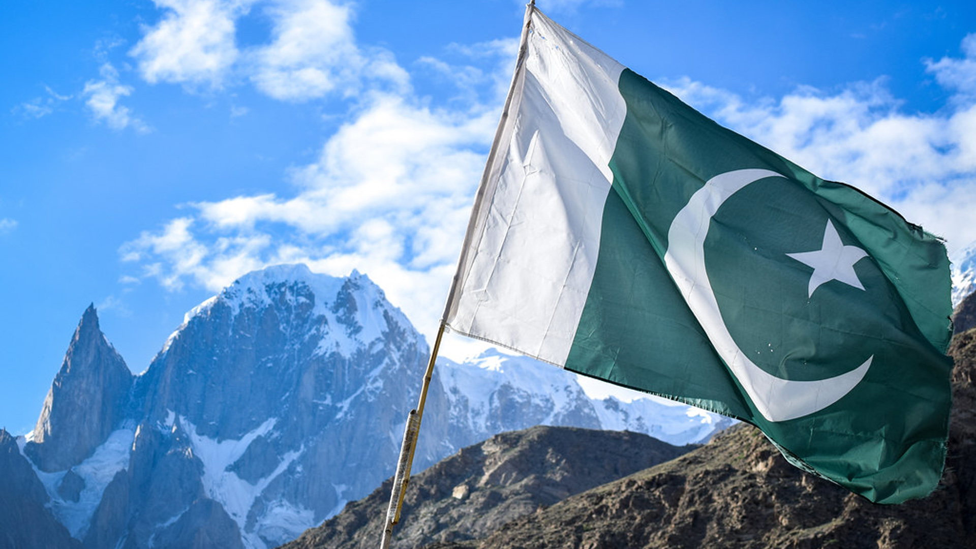 Pakistan Flag In White Covered Mountain Wallpaper Under White Clouds Blue Sky 2K Pakistan Flag