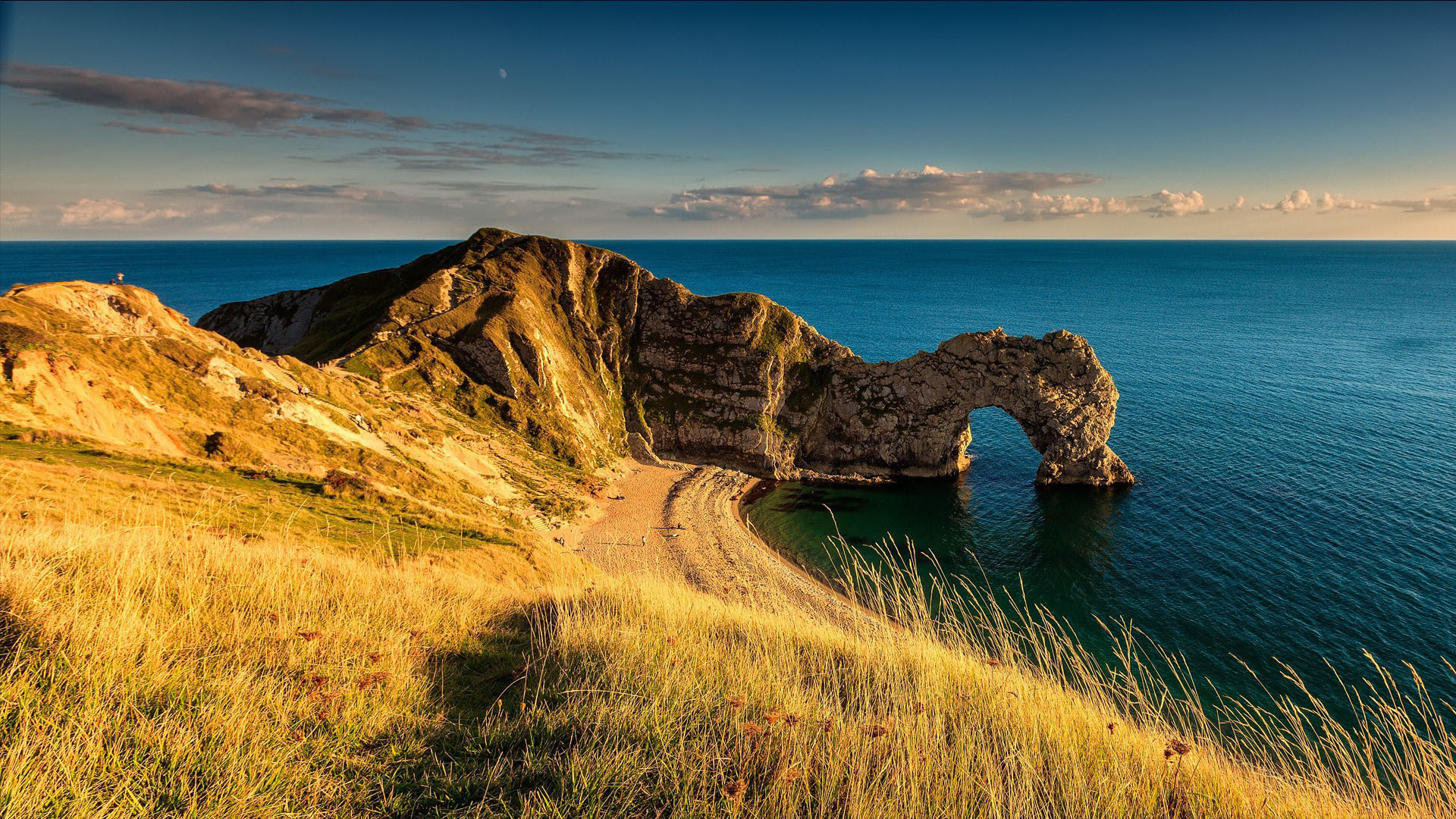 Durdle Door On Ocean Green Dry Grass Field Under White Clouds Blue Sky 2K Nature