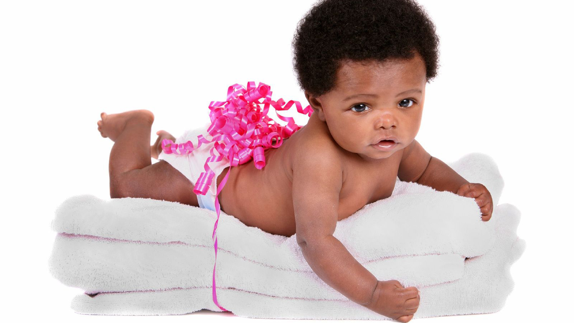 Cute Black Baby Is Lying On White Towel With White Wallpaper 2K Cute