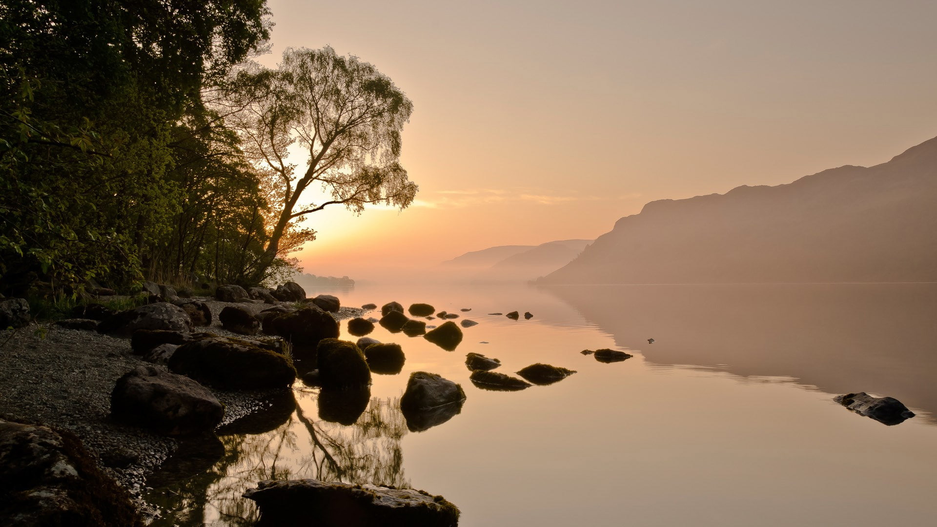 Stones On Calm Body Of Water Landscape View Of Fog Covered Mountains During Sunrise Scenery 2K Nature