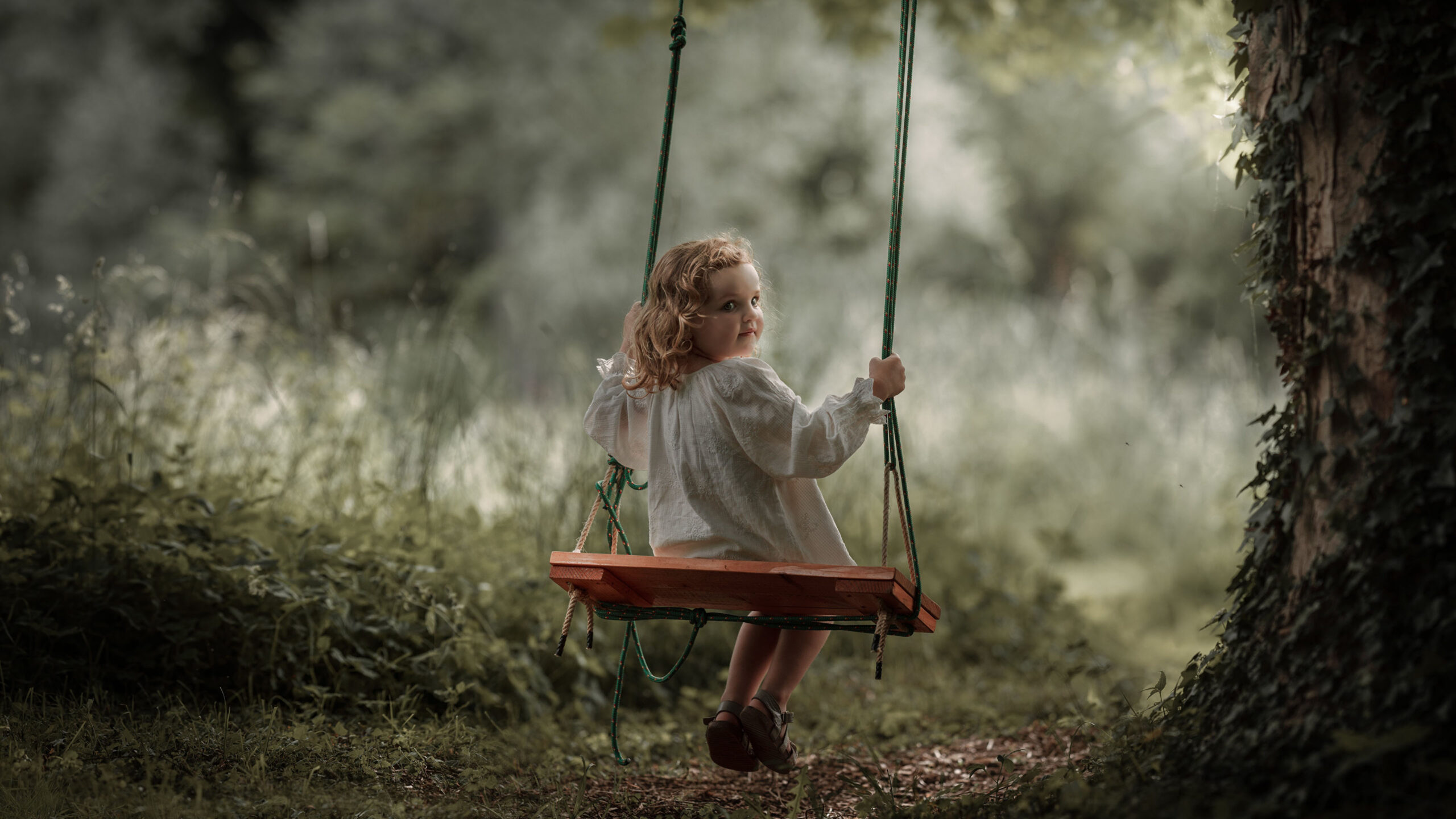 Cute Little Girl Is Sitting On Swing Looking Back Wearing White Dress In Blur Wallpaper K 2K Cute