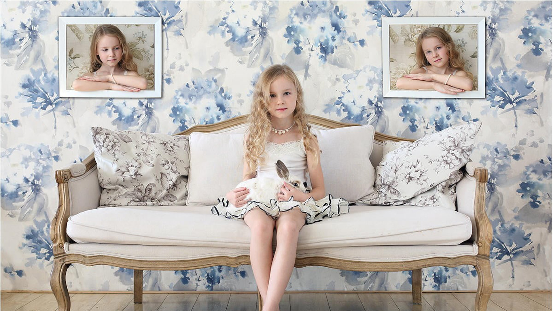 Cute Little Girl Is Having Rabbit On Lap Sitting On White Couch Wearing White Dress 2K Cute