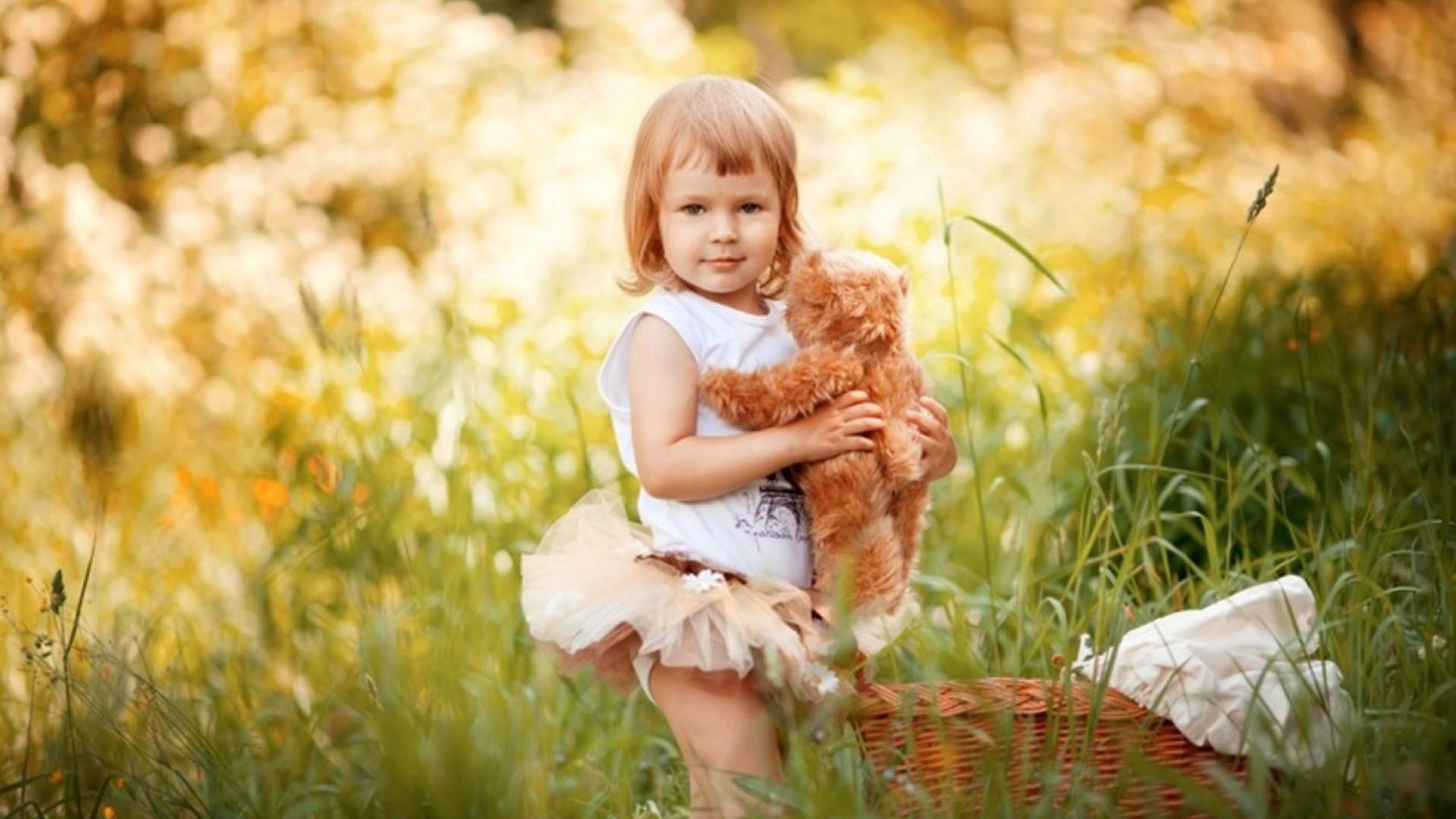 Cute Little Girl Is Standing With Toy On Green Grass Wearing White Dress In Blur Bokeh Wallpaper 2K Cute