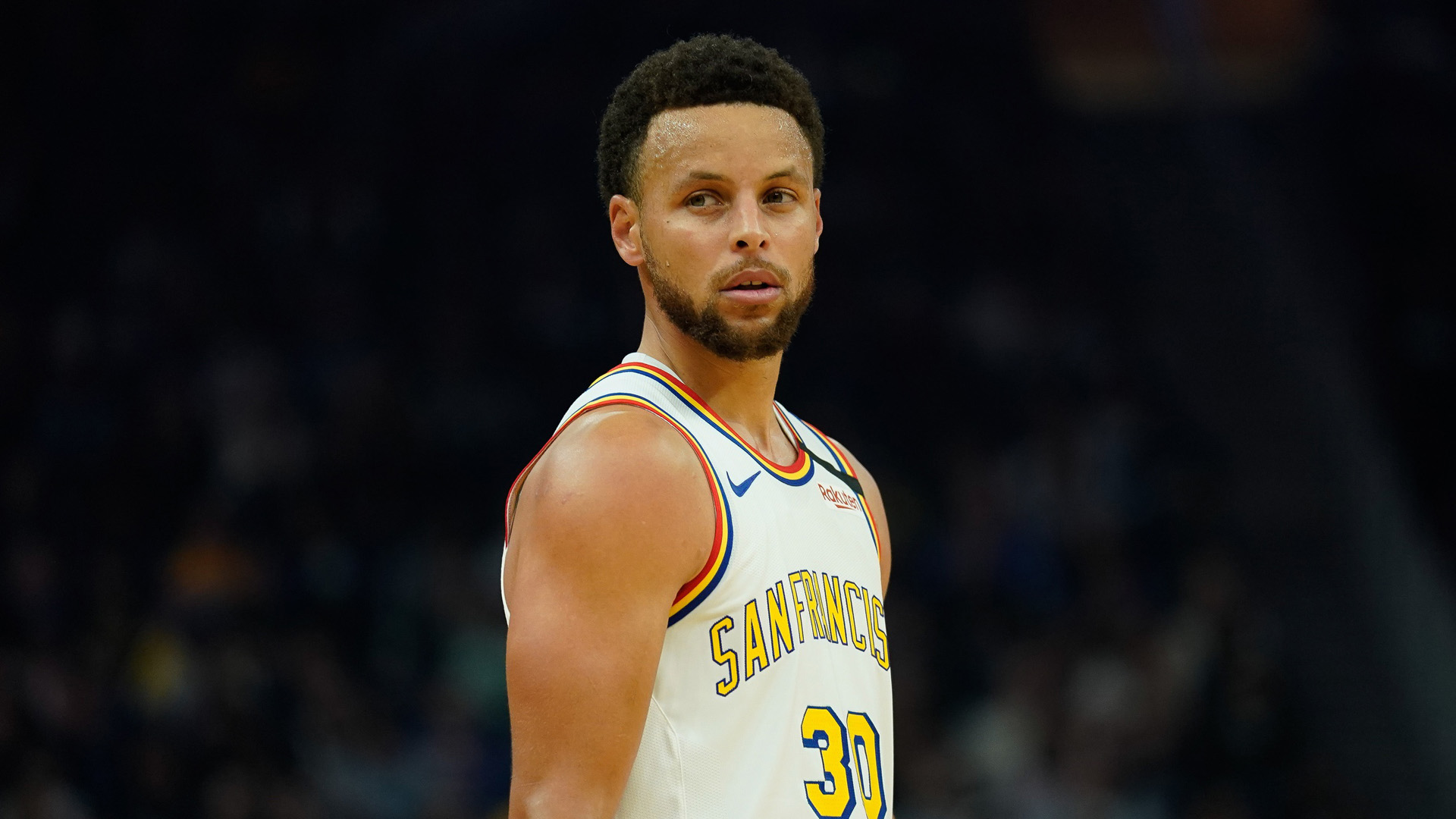 Stephen Curry Is Standing In Black Wallpaper Wearing White Sports Dress 2K Stephen Curry